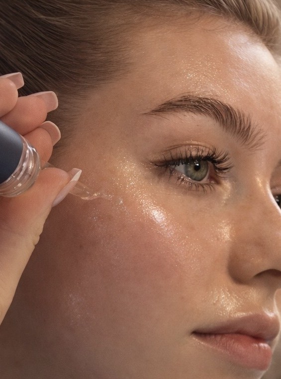Woman applying serum during an at-home skincare ritual